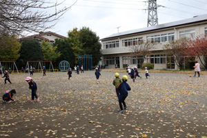 落ち葉模様の庭を走り回る子ども達。
